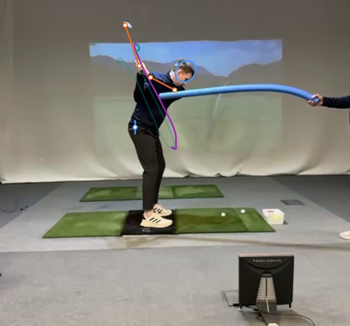 Early downswing drill image showing the student beginning to organise around the noodle constraint.