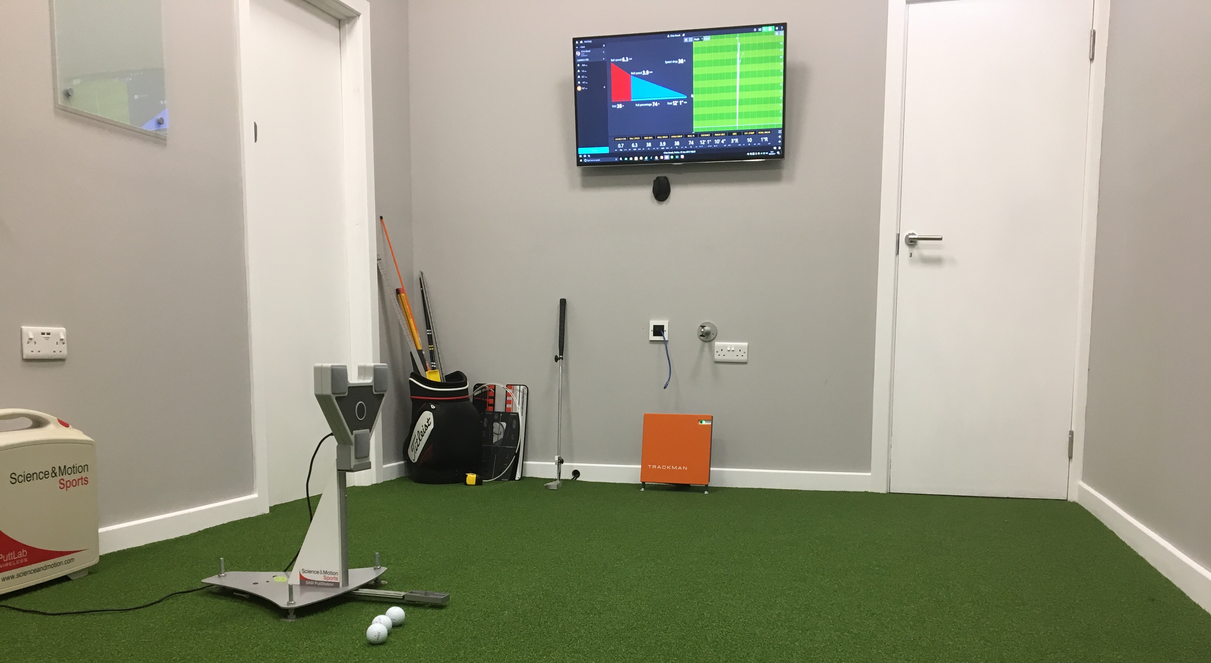 Chris Brook's putting studio near Bournemouth, with SAM PuttLab, TrackMan Putt and a screen showing launch, skid and roll data