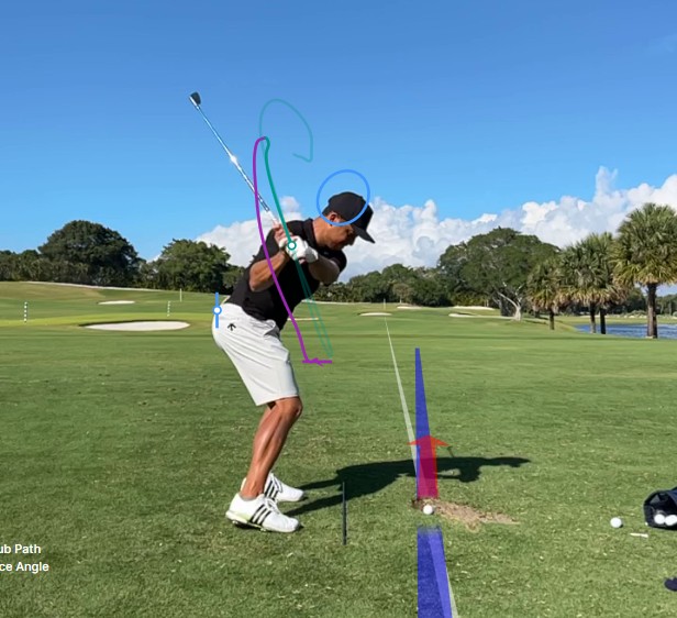 Tour player downswing frame showing hand trail and delivery corridor